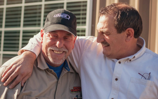 two men hugging with smiles on their face